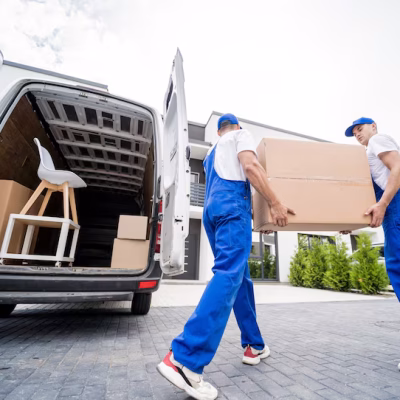 two-removal-company-workers-unloading-boxes-furniture-from-minibus_179755-13990